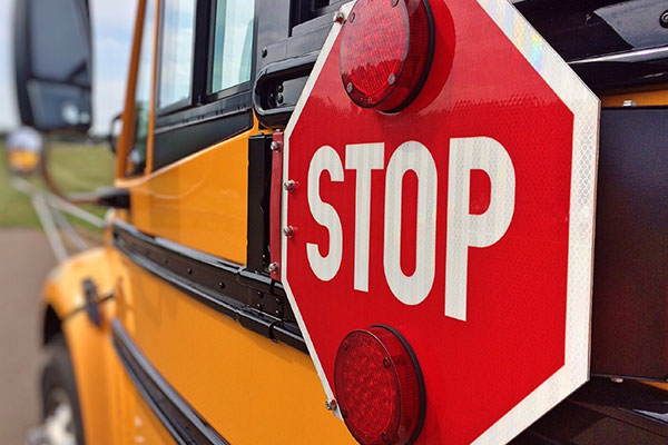 Closeup image of the stop sign on a school bus