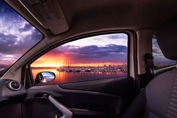 View out of a car window overlooking a New England harbor